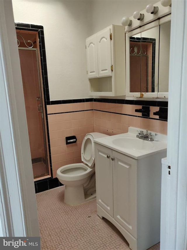 3138 Longshore Ave, Philadelphia, PA 19149 - full bathroom with a shower stall, vanity, tile walls, a wainscoted wall, and toilet