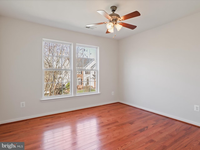 spare room featuring wood finished floors and baseboards
