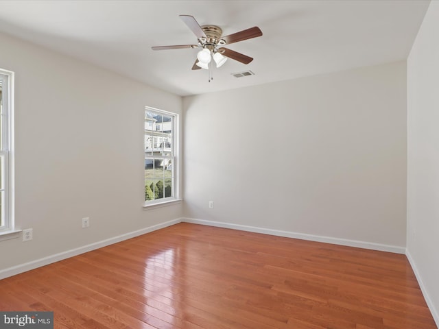 empty room with light wood-type flooring, baseboards, and ceiling fan