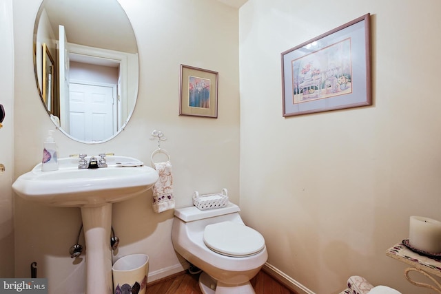 106 River Oaks, Baltimore, MD 21208 - bathroom with wood finished floors, toilet, and baseboards