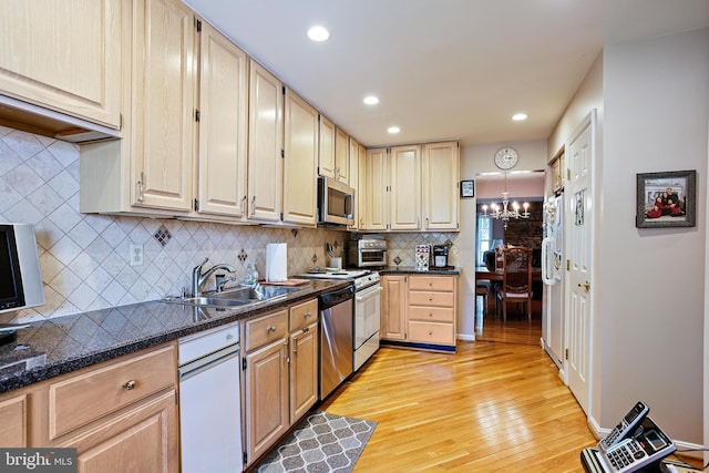 106 River Oaks, Baltimore, MD 21208 - kitchen with a sink, light wood-style flooring, stainless steel appliances, a chandelier, and backsplash