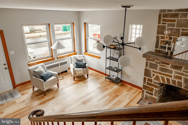 308 Cherry St, Columbia, PA 17512 - sitting room featuring radiator, healthy amount of natural light, and a stone fireplace
