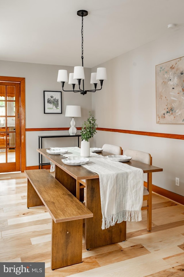 308 Cherry St, Columbia, PA 17512 - dining area with a chandelier, baseboards, and light wood-type flooring