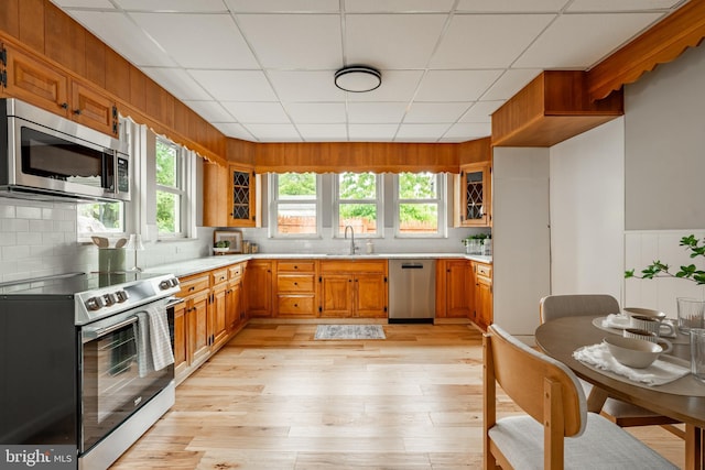308 Cherry St, Columbia, PA 17512 - kitchen featuring appliances with stainless steel finishes, light countertops, a sink, glass insert cabinets, and backsplash