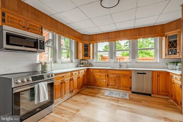 308 Cherry St, Columbia, PA 17512 - kitchen featuring appliances with stainless steel finishes, a sink, decorative backsplash, a paneled ceiling, and brown cabinetry