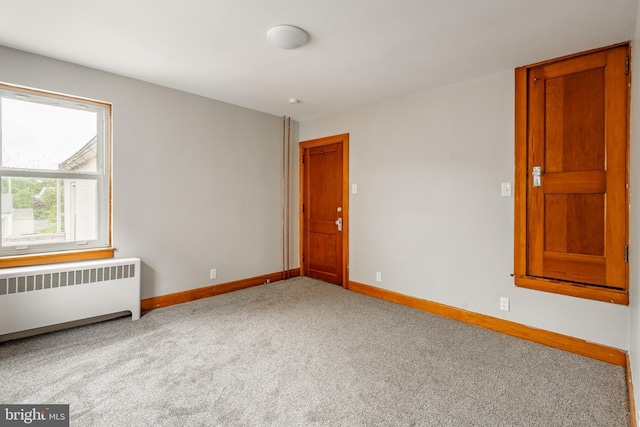 308 Cherry St, Columbia, PA 17512 - empty room with radiator heating unit, baseboards, and carpet floors
