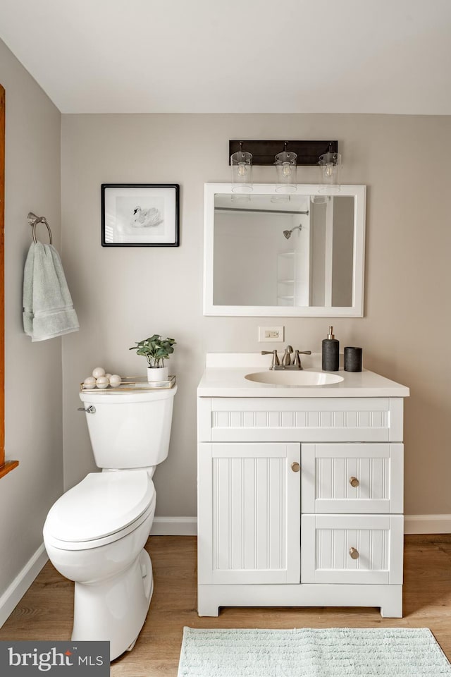 308 Cherry St, Columbia, PA 17512 - bathroom featuring wood finished floors, baseboards, toilet, and vanity
