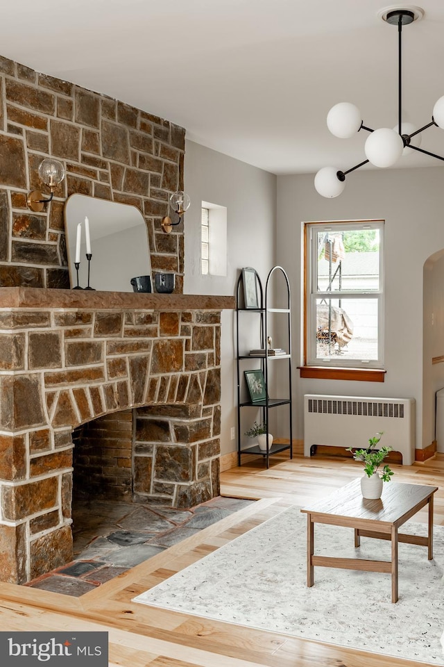 308 Cherry St, Columbia, PA 17512 - living area featuring radiator, wood finished floors, arched walkways, and baseboards