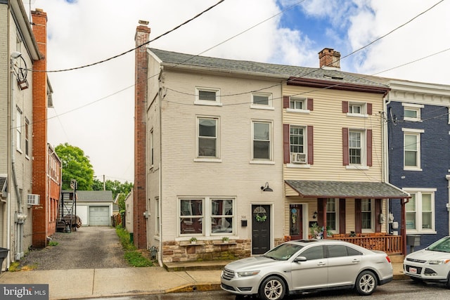 308 Cherry St, Columbia, PA 17512 - townhome / multi-family property with an outdoor structure, a detached garage, and cooling unit