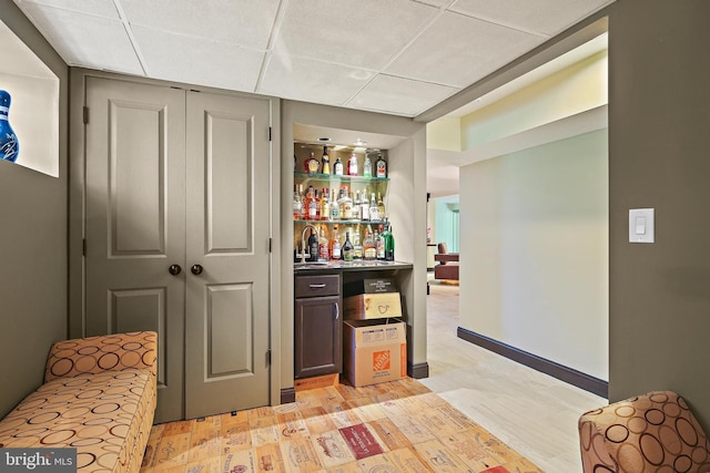 3503 Arborwood Ct, Baltimore, MD 21208 - indoor dry bar featuring a paneled ceiling and light wood-style floors