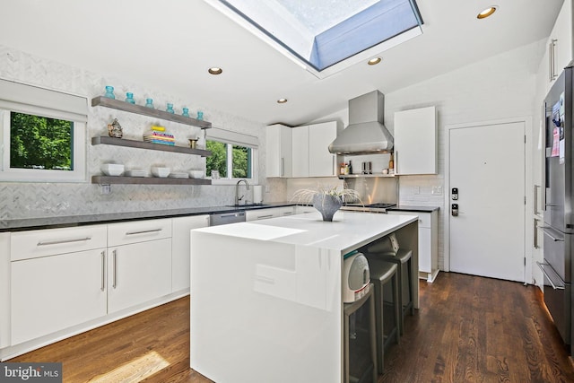 3503 Arborwood Ct, Baltimore, MD 21208 - kitchen with wall chimney exhaust hood, open shelves, vaulted ceiling, a sink, and a skylight