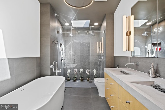 3503 Arborwood Ct, Baltimore, MD 21208 - bathroom featuring tile walls, tile patterned flooring, vanity, a freestanding bath, and a walk in shower