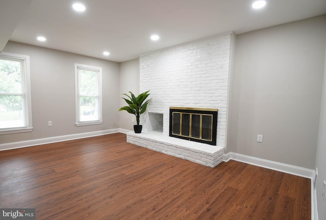 8514 Magnolia Dr, Lanham, MD 20706 - unfurnished living room with dark wood-style floors, baseboards, recessed lighting, and a brick fireplace