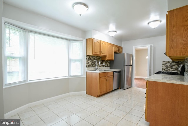 8514 Magnolia Dr, Lanham, MD 20706 - kitchen with appliances with stainless steel finishes, a sink, light countertops, and backsplash