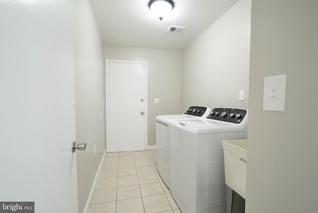 8514 Magnolia Dr, Lanham, MD 20706 - laundry area featuring washing machine and dryer, light tile patterned floors, and baseboards