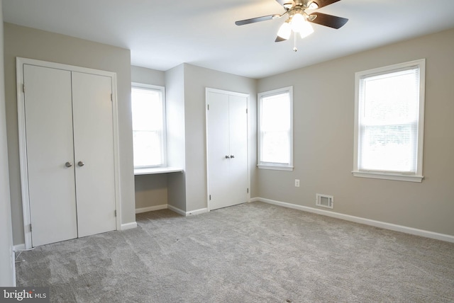 8514 Magnolia Dr, Lanham, MD 20706 - unfurnished bedroom with two closets, carpet floors, multiple windows, and baseboards