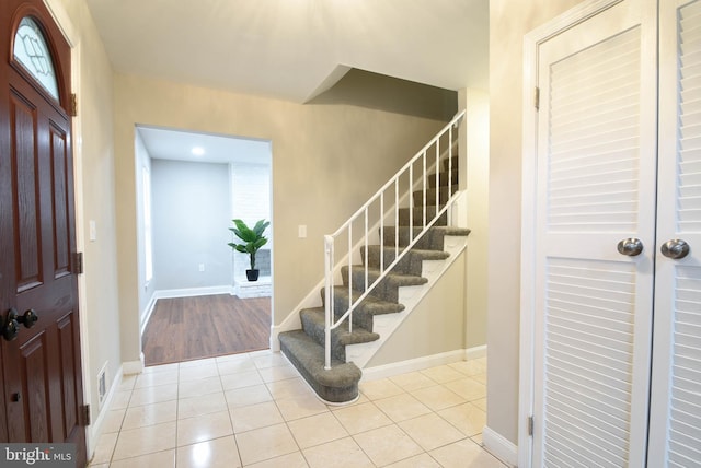 8514 Magnolia Dr, Lanham, MD 20706 - entrance foyer featuring stairway, light tile patterned floors, and baseboards