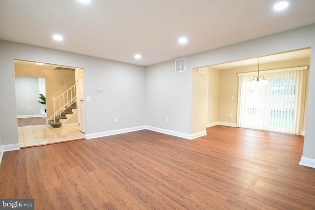 8514 Magnolia Dr, Lanham, MD 20706 - empty room with stairs, wood finished floors, recessed lighting, and baseboards