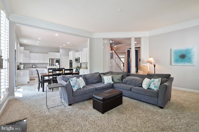 42743 Macauley Pl, Ashburn, VA 20148 - living room with ornamental molding, light colored carpet, stairs, baseboards, and recessed lighting