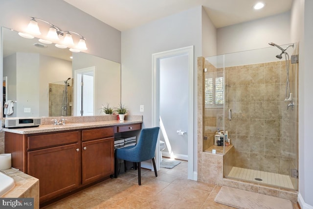 42743 Macauley Pl, Ashburn, VA 20148 - bathroom with a shower stall, tile patterned flooring, vanity, baseboards, and toilet