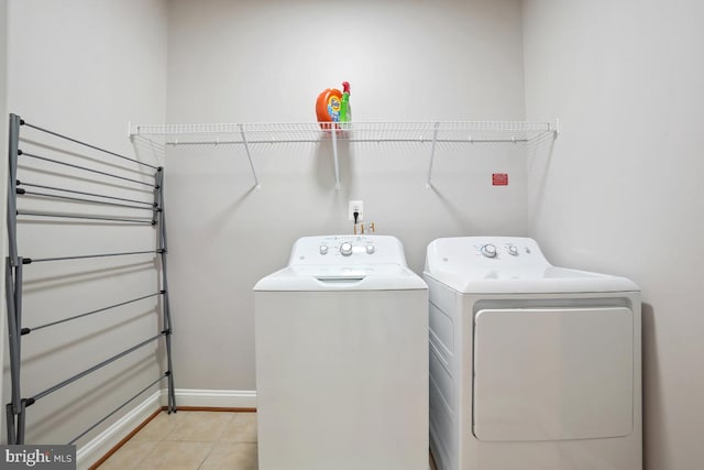 42743 Macauley Pl, Ashburn, VA 20148 - washroom featuring washing machine and dryer, light tile patterned floors, and baseboards
