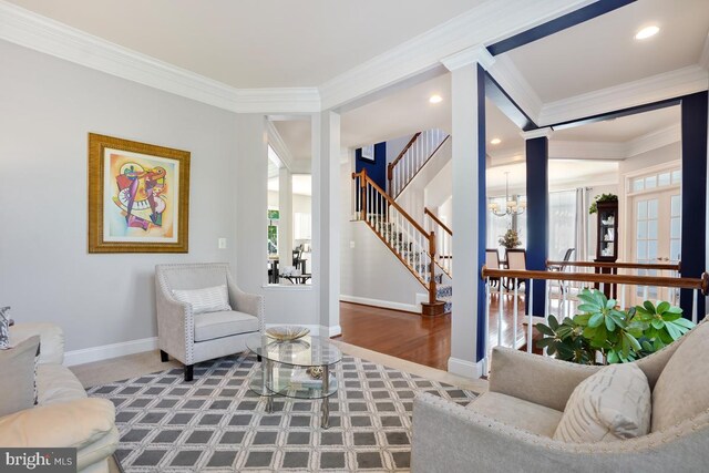 42743 Macauley Pl, Ashburn, VA 20148 - living room featuring ornamental molding, healthy amount of natural light, stairs, baseboards, and a chandelier