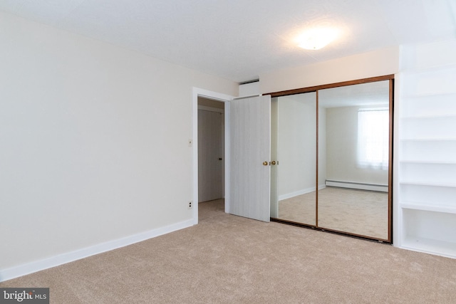 102 S Poplar Ave, Maple Shade, NJ 08052 - unfurnished bedroom with a baseboard heating unit, carpet, a closet, and baseboards