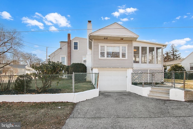 102 S Poplar Ave, Maple Shade, NJ 08052 - view of front of home featuring a sunroom, an attached garage, driveway, fence, and a gate