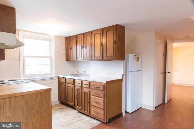 102 S Poplar Ave, Maple Shade, NJ 08052 - kitchen with freestanding refrigerator, a sink, light countertops, brown cabinets, and baseboards
