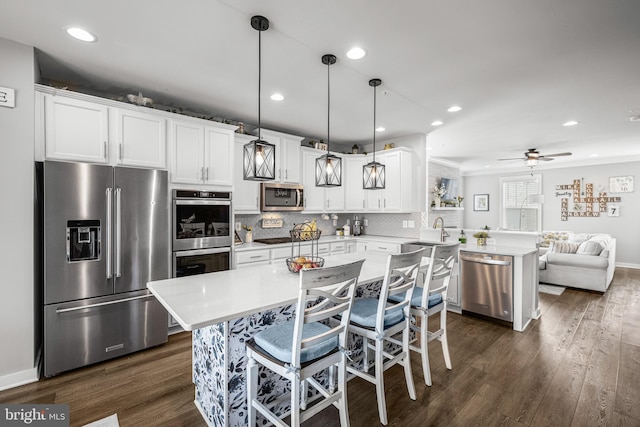 3451 Flatwoods Dr, Frederick, MD 21704 - kitchen featuring stainless steel appliances, a peninsula, light countertops, dark wood finished floors, and recessed lighting