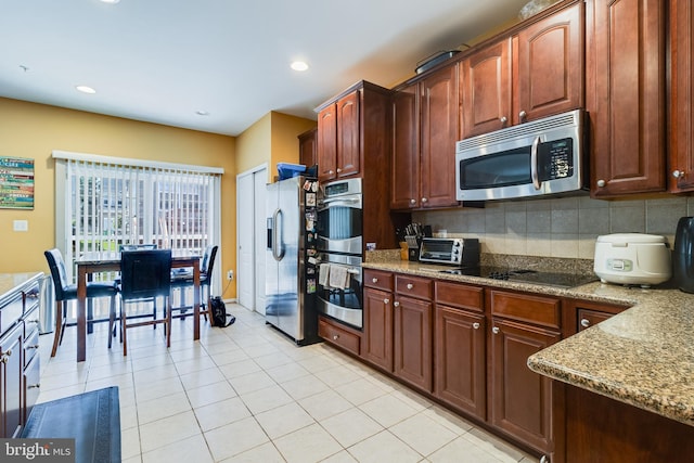 15603 Chadsey Ln, Brandywine, MD 20613 - kitchen with appliances with stainless steel finishes, light stone countertops, backsplash, light tile patterned floors, and recessed lighting