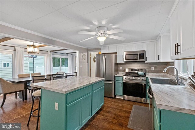 272 Main St, Hamilton, NJ 08620 - kitchen with appliances with stainless steel finishes, green cabinetry, a sink, white cabinetry, and ornamental molding