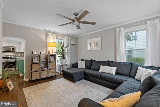 272 Main St, Hamilton, NJ 08620 - living area with crown molding, dark wood finished floors, ceiling fan, and arched walkways
