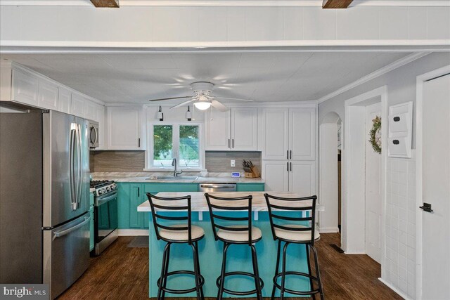 272 Main St, Hamilton, NJ 08620 - kitchen with appliances with stainless steel finishes, a sink, light countertops, dark wood-style floors, and white cabinetry
