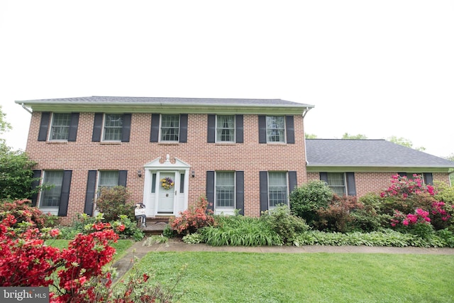 4308 Joshua Court, St, MD 21154 - colonial house featuring a front lawn and brick siding