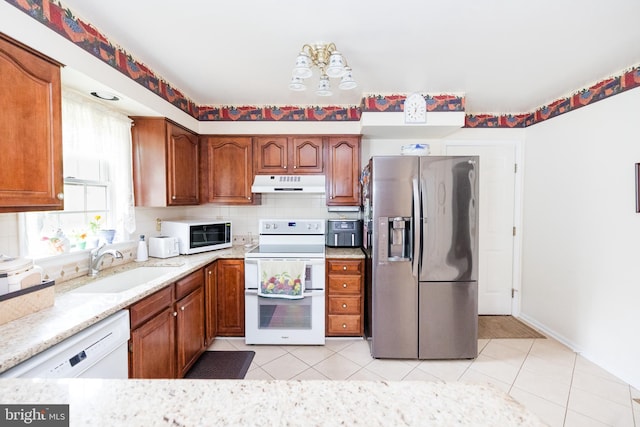 4308 Joshua Court, St, MD 21154 - kitchen featuring white appliances, under cabinet range hood, a sink, and brown cabinets
