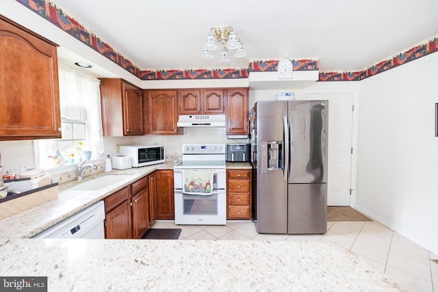 4308 Joshua Court, St, MD 21154 - kitchen with white appliances, under cabinet range hood, a sink, light tile patterned floors, and tasteful backsplash