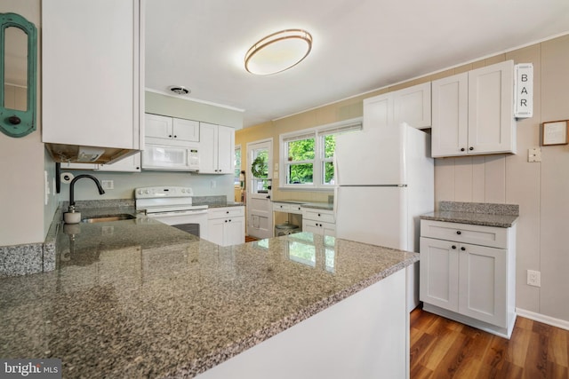 kitchen with white appliances, a sink, light stone counters, dark wood-style floors, and white cabinetry