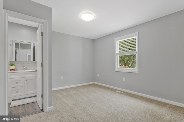 402 Bay View Dr, Edgewater, MD 21037 - unfurnished bedroom with carpet floors, baseboards, ensuite bath, and a sink
