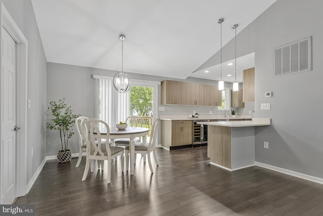 402 Bay View Dr, Edgewater, MD 21037 - kitchen featuring wine cooler, light countertops, dark wood-type flooring, plenty of natural light, and vaulted ceiling