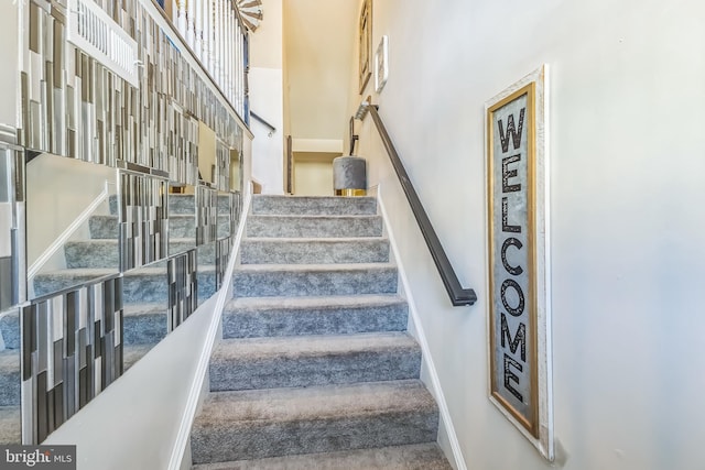 7109 Yamhill Way, Glen Burnie, MD 21060 - stairs featuring a towering ceiling, baseboards, and carpet flooring