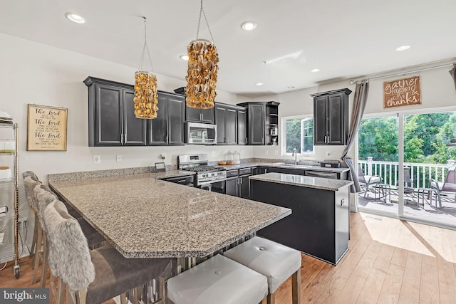 7109 Yamhill Way, Glen Burnie, MD 21060 - kitchen featuring stainless steel appliances, a sink, a peninsula, recessed lighting, and light wood-style flooring