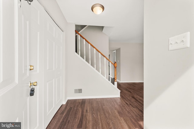 9048 Bonham Cir, Manassas, VA 20110 - foyer entrance with wood finished floors, baseboards, and stairs