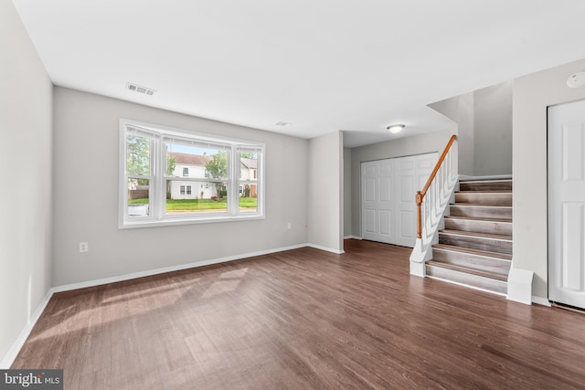 9048 Bonham Cir, Manassas, VA 20110 - unfurnished living room featuring stairway, wood finished floors, and baseboards