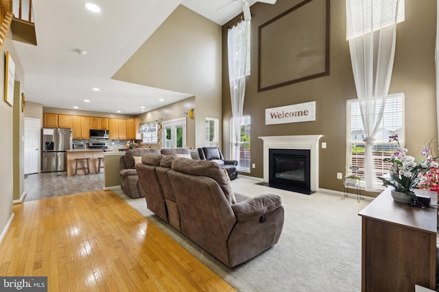 7 Otto Way, Fredericksburg, VA 22406 - living area with a towering ceiling, baseboards, a fireplace with flush hearth, recessed lighting, and light wood-type flooring