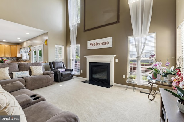 7 Otto Way, Fredericksburg, VA 22406 - living area featuring a high ceiling, carpet floors, a fireplace with flush hearth, and baseboards