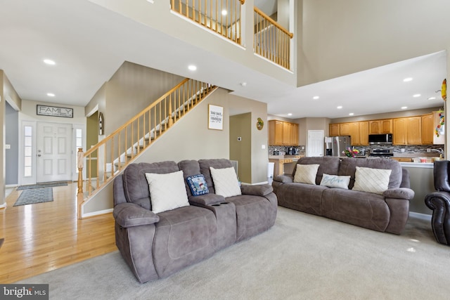 7 Otto Way, Fredericksburg, VA 22406 - living area featuring stairway, recessed lighting, light wood-style floors, a high ceiling, and baseboards