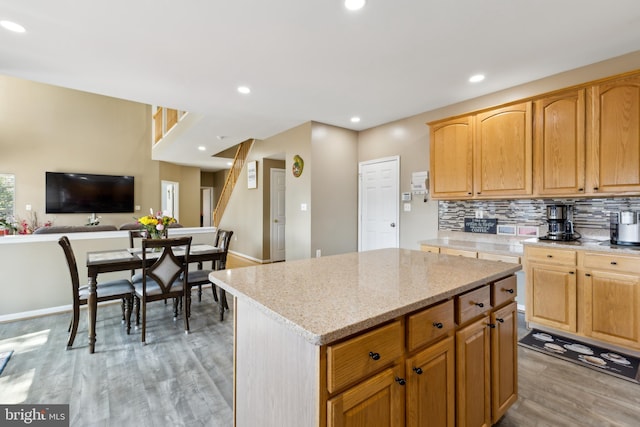 7 Otto Way, Fredericksburg, VA 22406 - kitchen featuring light wood finished floors, recessed lighting, a kitchen island, light stone counters, and backsplash