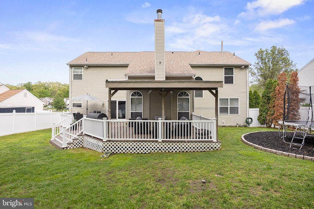 106 Hedgerow Ct, Deptford, NJ 08096 - back of property with a trampoline, a chimney, roof with shingles, and a deck