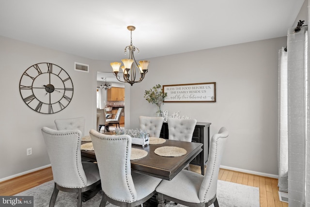 106 Hedgerow Ct, Deptford, NJ 08096 - dining room featuring a chandelier, light wood-style floors, and baseboards